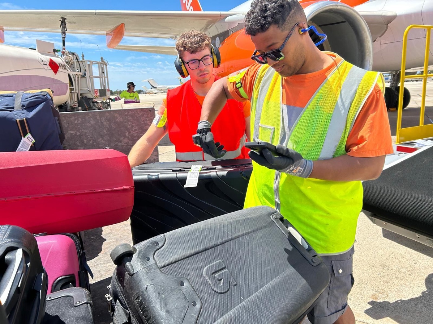 Ground crew scanning baggage at the aircraft